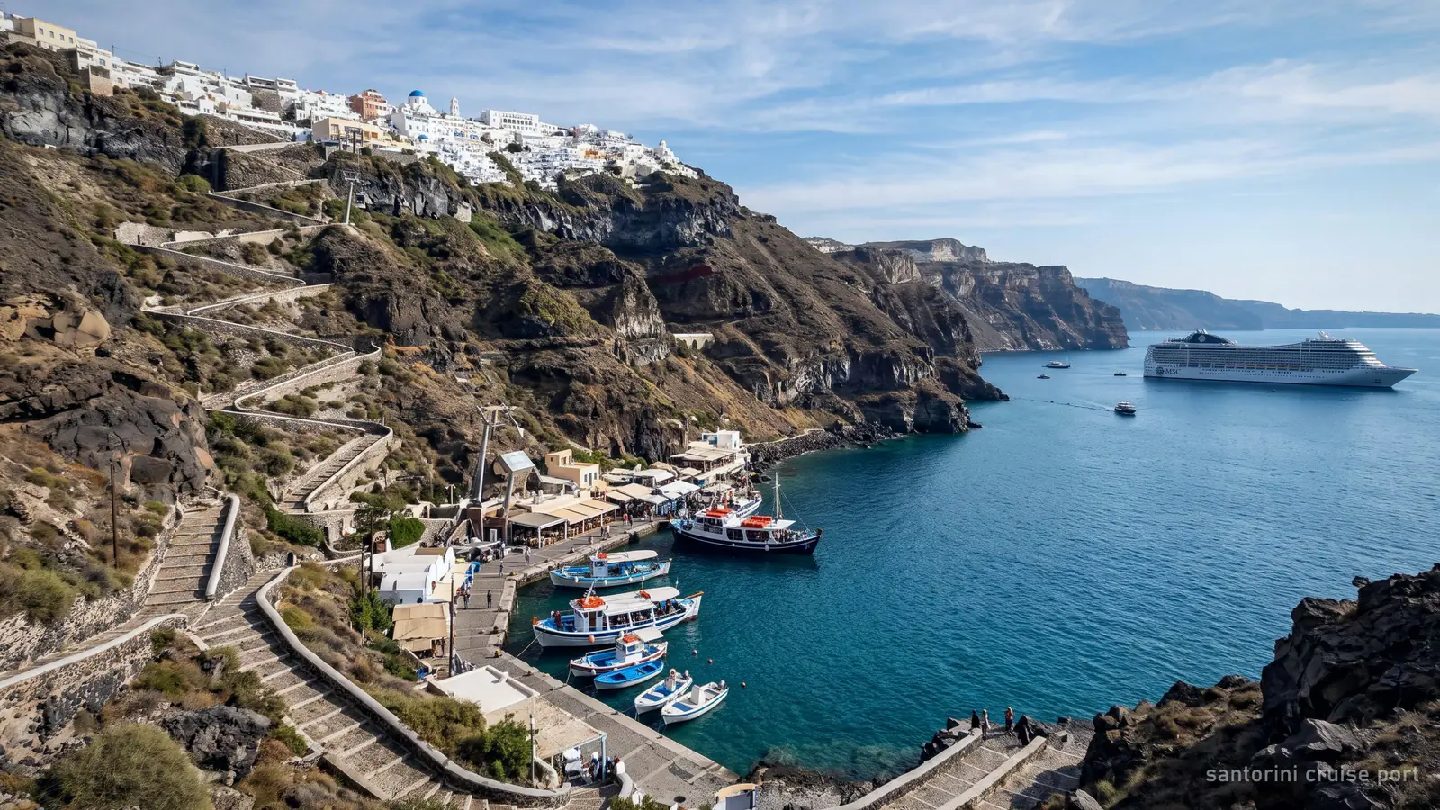The Old Port of Fira below the cliff, the zigzag path and cable car rising to Fira, a cruise ship at anchor